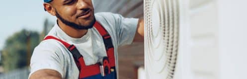 Las Vegas HVAC technician diagnosing an outdoor AC unit during a repair visit