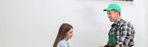 Las Vegas homeowner reviewing AC repair vs replacement options with a technician