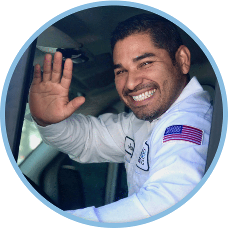 Employee waving from inside service van