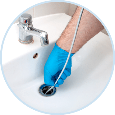 Plumber performing drain cleaning in Las Vegas sink using professional drainage cleaning services