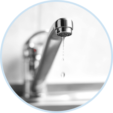Plumber repairing leaking pipe under sink during professional plumbing leak detection services