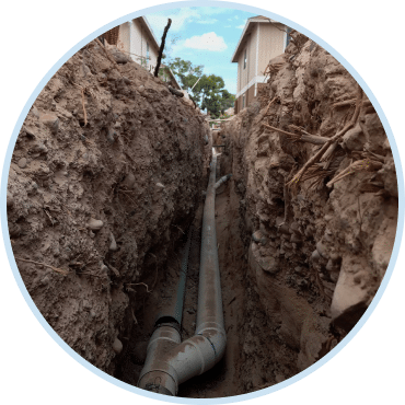 Sewer line repair services in Las Vegas with new pipe installation in trench